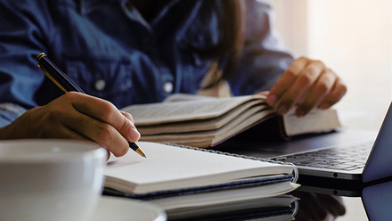 Person writing in book thumbnail.jpg