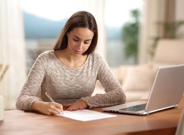 Person filling in form while sat at laptop.jpg