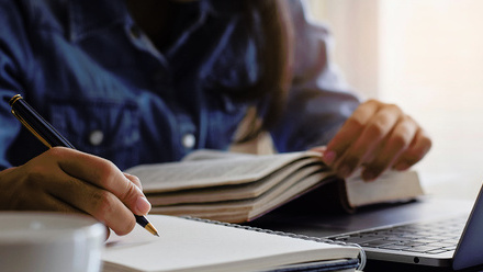 Person writing in book.jpg