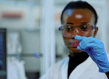 Female scientist holding slide_sq.jpg