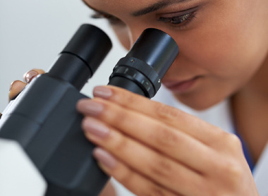 Women looking down microscope for exam_low res.jpg