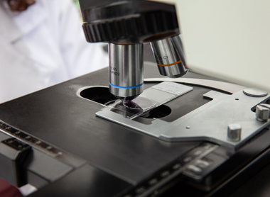 Scientist looking at liquid based cytology pap smear samples through a microscope shutterstock_2209149077.jpg